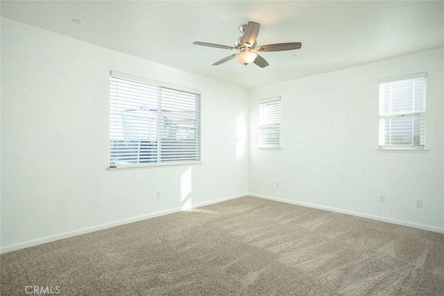 spare room featuring carpet and ceiling fan