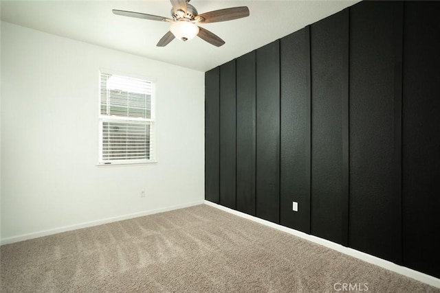 carpeted spare room with ceiling fan