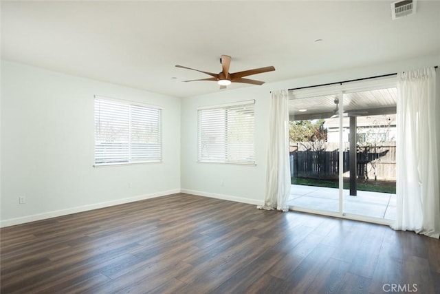 spare room with ceiling fan and dark hardwood / wood-style flooring