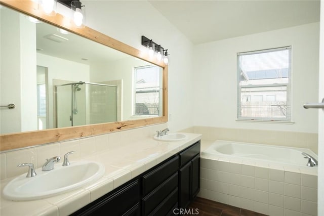 bathroom with hardwood / wood-style floors, vanity, and independent shower and bath