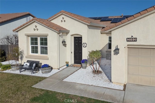 view of front of house with solar panels and a garage