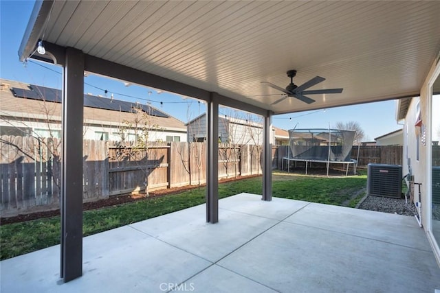 view of patio with a trampoline, ceiling fan, and central AC