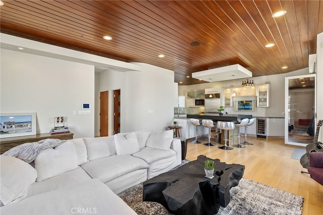 living room featuring recessed lighting, wine cooler, light wood-style flooring, and wooden ceiling