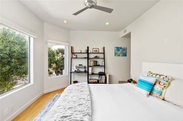 bedroom with light wood finished floors, visible vents, baseboards, recessed lighting, and a ceiling fan