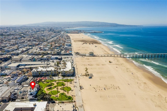 birds eye view of property featuring a beach view and a water view