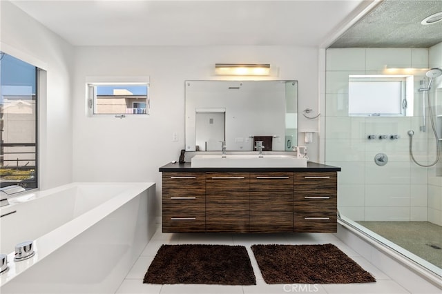 full bath featuring a bath, tile patterned flooring, a stall shower, and vanity