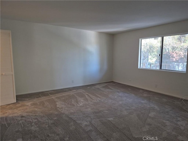 empty room with dark colored carpet