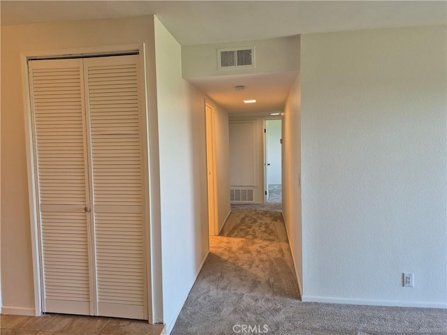 hallway with light colored carpet