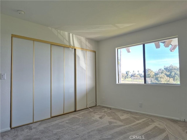 unfurnished bedroom featuring light colored carpet