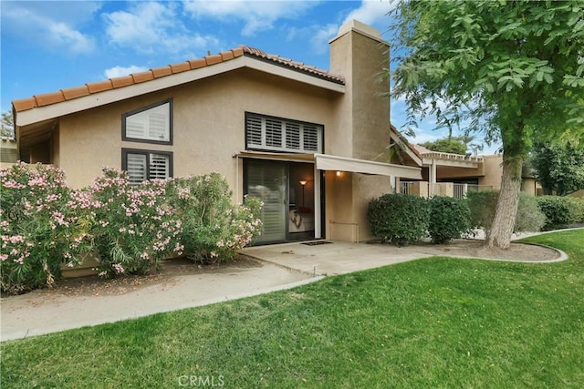 rear view of property with a patio area and a lawn