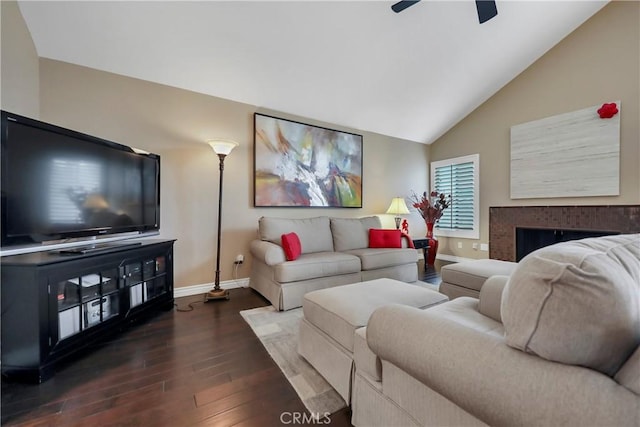 living room featuring ceiling fan, hardwood / wood-style floors, and vaulted ceiling