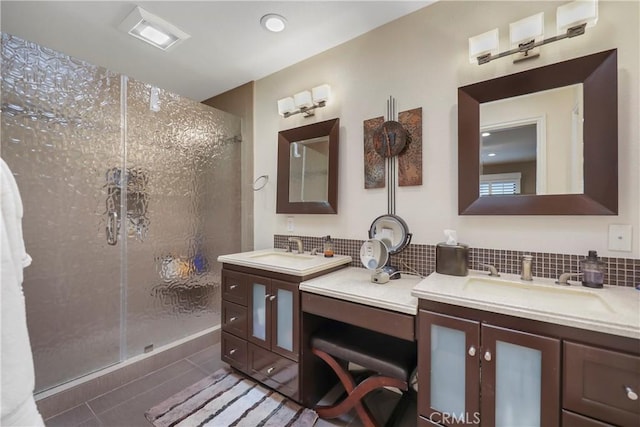 bathroom featuring an enclosed shower, vanity, tile patterned floors, and tasteful backsplash