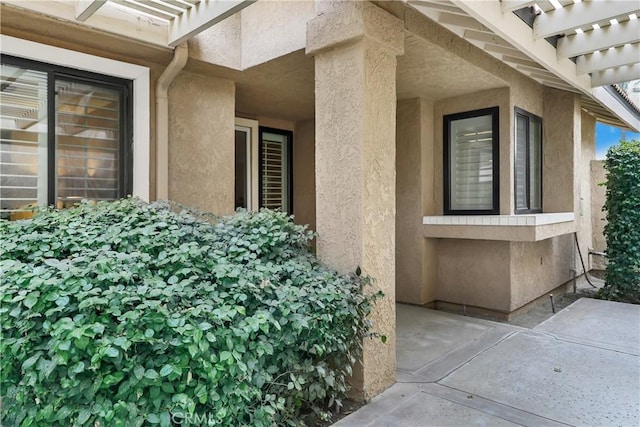 entrance to property featuring a pergola