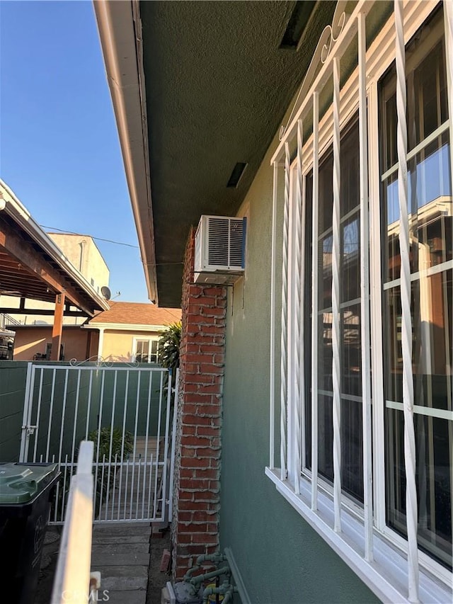 view of home's exterior featuring a wall unit AC