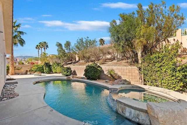 view of pool with a mountain view and an in ground hot tub