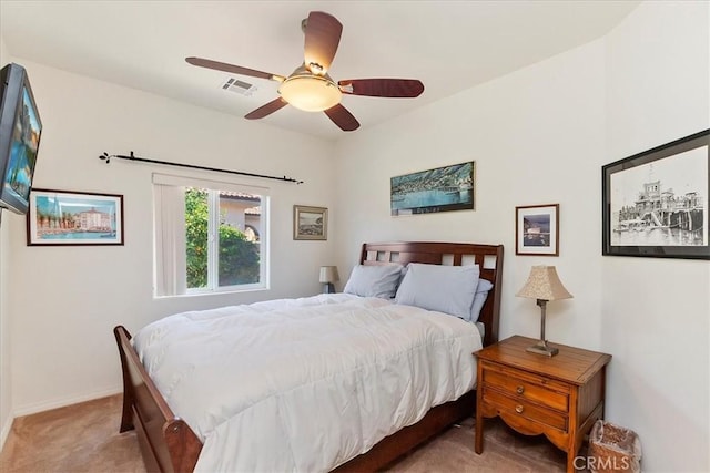 bedroom with ceiling fan and light carpet