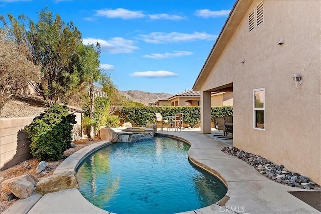 view of pool featuring a mountain view and a patio