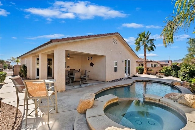 view of swimming pool with an in ground hot tub, a patio, and ceiling fan