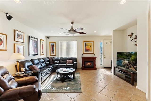 tiled living room featuring ceiling fan