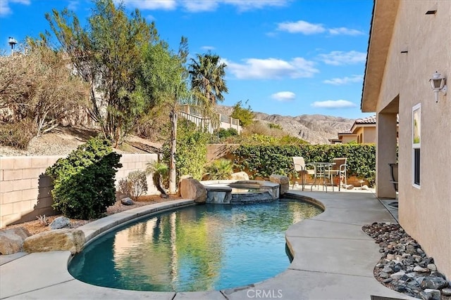 view of swimming pool featuring a mountain view, an in ground hot tub, and a patio