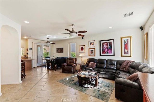 tiled living room with ceiling fan