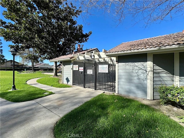 view of gate featuring a yard