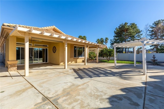 back of property featuring a pergola, a patio area, and ceiling fan