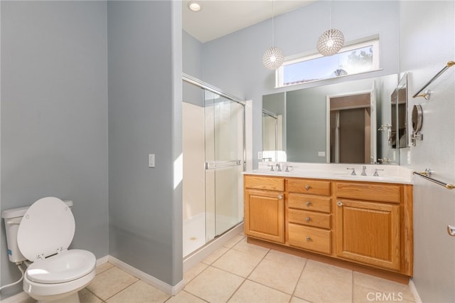 bathroom featuring tile patterned flooring, vanity, toilet, and walk in shower