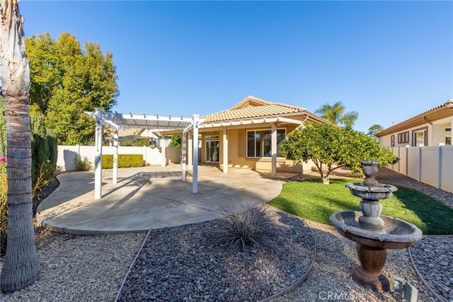 back of property with a pergola and a patio