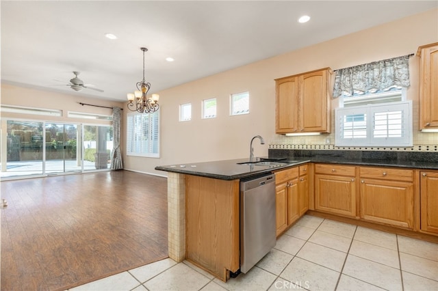 kitchen with stainless steel dishwasher, ceiling fan with notable chandelier, sink, decorative light fixtures, and light tile patterned flooring