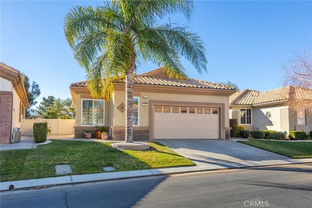 mediterranean / spanish-style house featuring a front yard and a garage