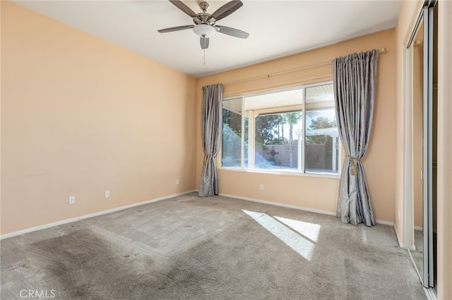 spare room featuring light carpet and ceiling fan