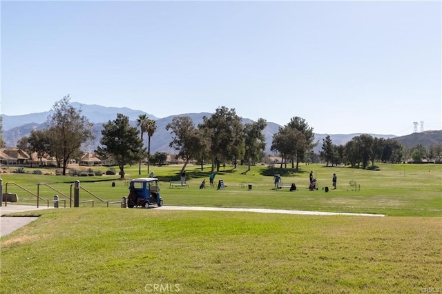 surrounding community featuring a mountain view and a yard