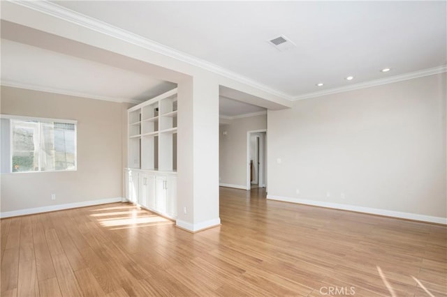 unfurnished room with light wood-type flooring and crown molding