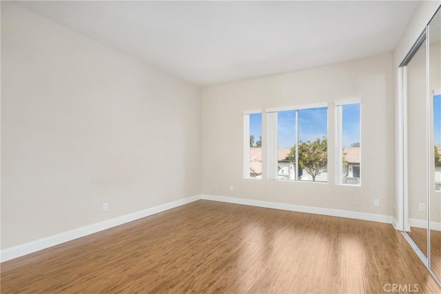 spare room with hardwood / wood-style floors