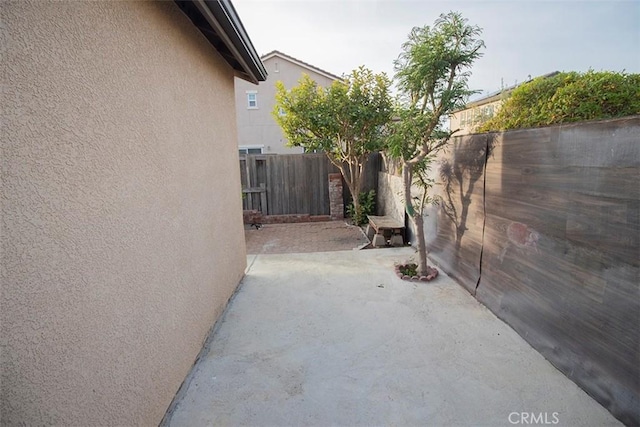 view of side of property with a patio