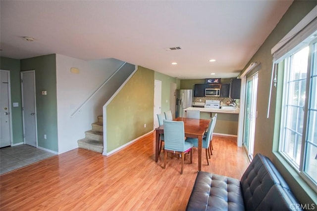 dining space with light hardwood / wood-style flooring