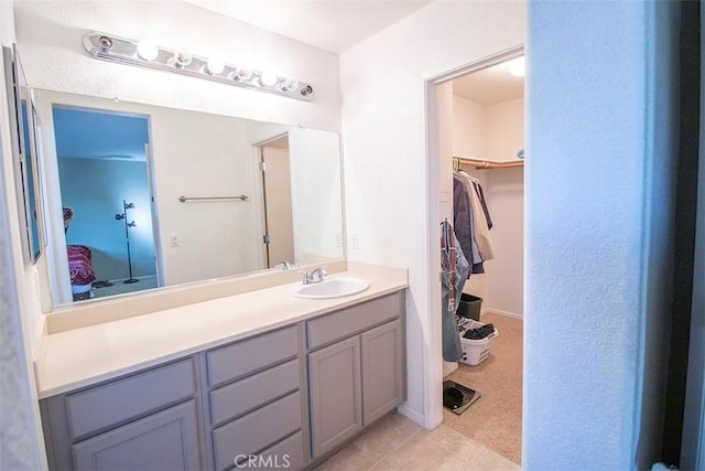 bathroom featuring tile patterned flooring and vanity