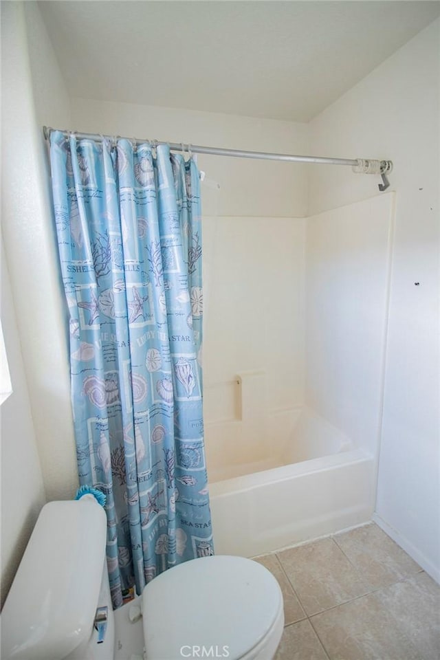 bathroom with tile patterned floors, toilet, and shower / bathtub combination with curtain