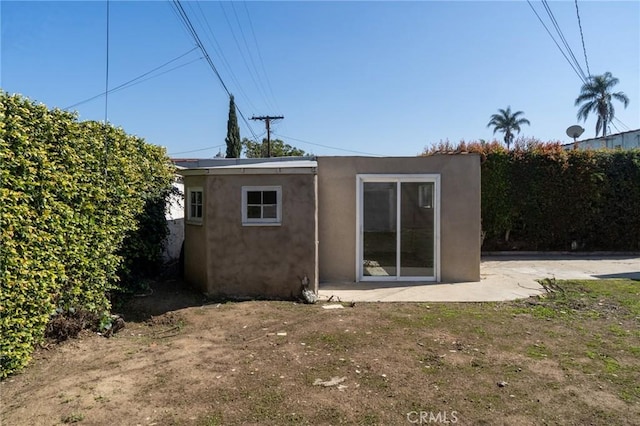 back of property with stucco siding