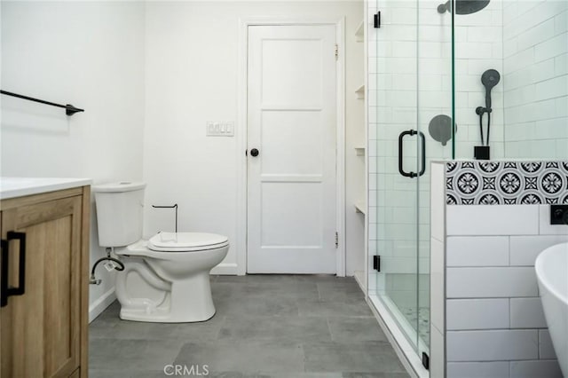 bathroom with a stall shower, toilet, and baseboards