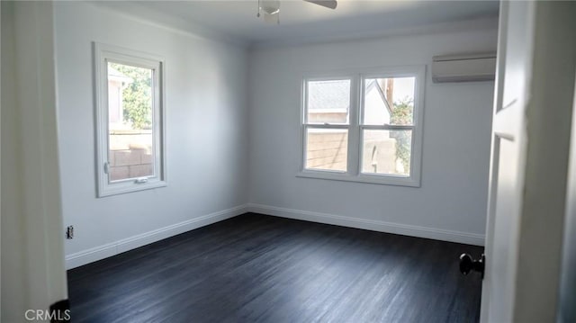 empty room with a ceiling fan, an AC wall unit, dark wood finished floors, and baseboards