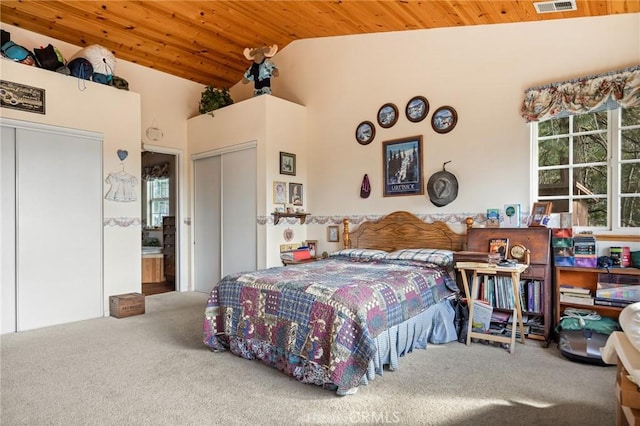 carpeted bedroom with lofted ceiling and wood ceiling