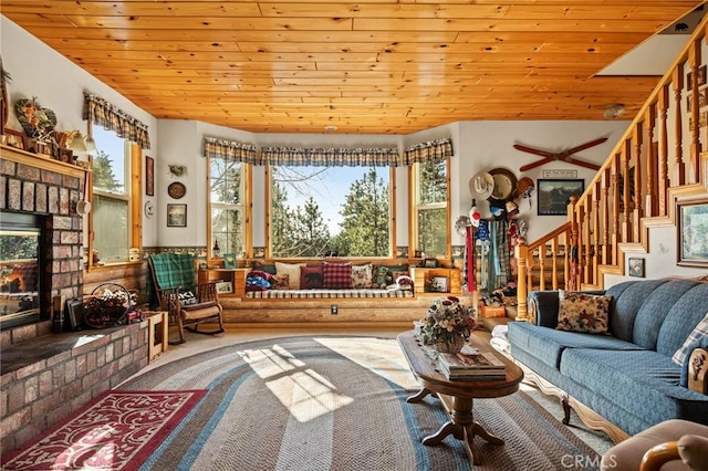 carpeted living room featuring vaulted ceiling and wooden ceiling