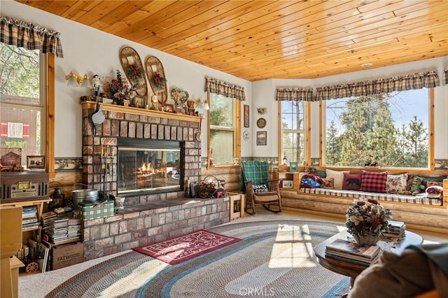 living room with a brick fireplace and wood ceiling