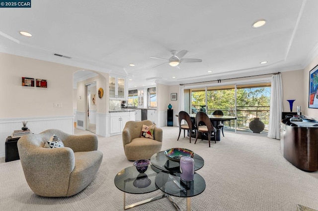 carpeted living room featuring ceiling fan