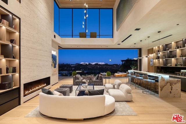 view of patio featuring an outdoor living space with a fireplace and exterior bar