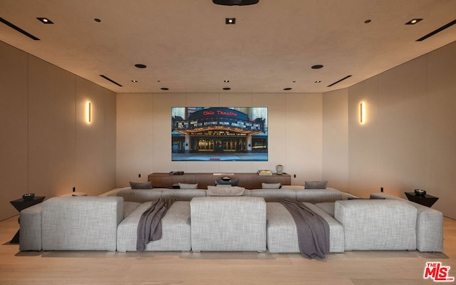 home theater room with light wood-type flooring