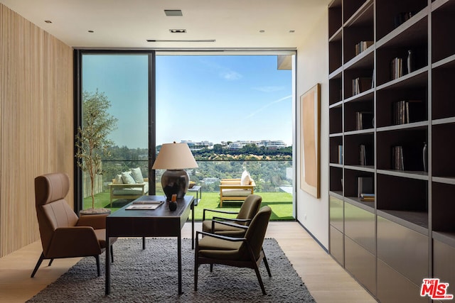 interior space featuring floor to ceiling windows and light wood-type flooring