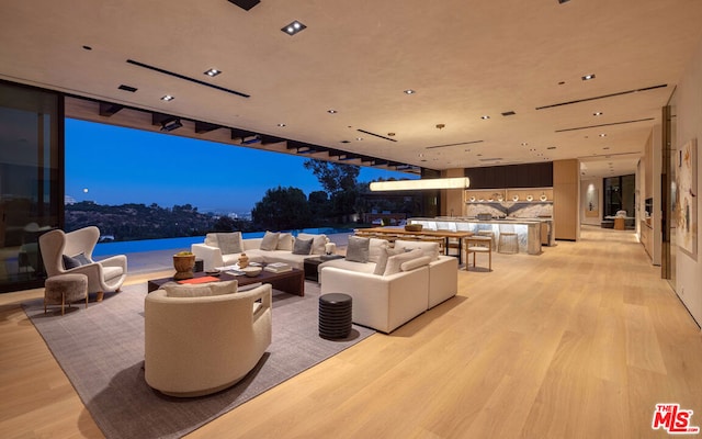 patio terrace at dusk with an outdoor living space and a water view